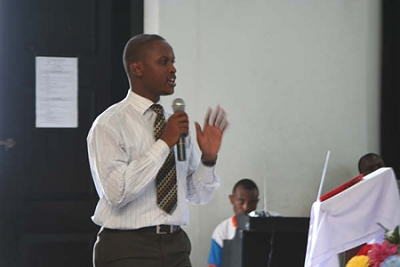 Costantine Magavilla presents to a group of youth at the University of Dar es Salaam at a Youth Summit organized by Roots & Shoots Tanzania. One of the luminary presenters at the summit was Dr. Jane Goodall.